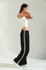 Pantalon de jogging de corte amplio y tiro medio, color gris melange, con cintura elástica y detalle de franjas laterales en tono claro.