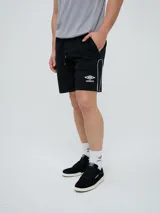 Bermuda deportiva Umbro modelo Veliz para hombre, color negro con detalles en blanco, cordón ajustable en la cintura y logo bordado en la pierna izquierda.