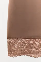 Vestido corto color marrón, confeccionado en mezcla de poliamida, con escote redondo y tirantes finos ajustables. El bajo está acabado con una aplicación de encaje combinado a tono.