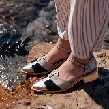 Zapatos de tacón bajo tipo sandalia cerrada, confeccionados en cuero con diseño tricolor en tonos plateado con textura de cocodrilo, negro y gris. Presentan punta fina, tira en el empeine en forma de T y tira ajustable al tobillo con hebilla. Cuentan con tacón cuadrado de madera.