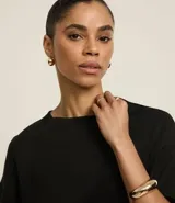 Blusa básica de algodón con corte oversized, cuello redondo y mangas cortas con sisas desplazadas. Diseño liso sin estampados.