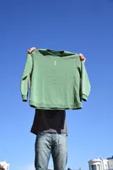 Buzo verde con cuello redondo y logo pequeño bordado en el pecho.