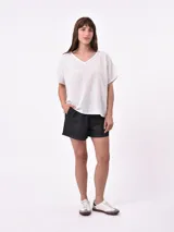Blusa lila de corte holgado con cuello en V y mangas cortas.