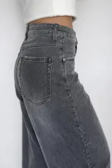 Jeans mom fit color gris, de tiro alto, con bolsillos delanteros y traseros. Confeccionado en algodón, lyocell y elastano.