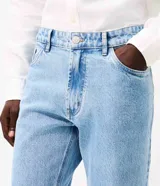 Pantalón de jean corte slim, color azul claro con lavado stonewash, con cierre frontal de botón y cremallera, presillas para cinturón y bolsillos funcionales.