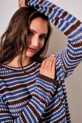 Sweater de punto con diseño de rayas horizontales en tonos ocre, marrón y crudo. Presenta cuello redondo, mangas largas y puños acanalados.