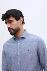 Camisa de lino y algodón color celeste melange, de manga larga, con cuello camisero, cierre frontal con botones y detalle de logo bordado en el pecho.