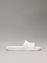 Ojotas blancas de Calvin Klein Jeans, con capellada de lona con logo estampado en negro.