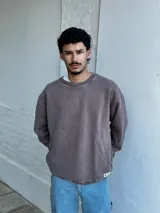 Buzo de cuello redondo con efecto lavado, de corte oversize y mangas largas con puños acanalados.