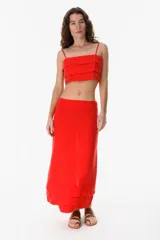 Top corto rojo de lino, con tirantes finos y diseño de capas superpuestas.