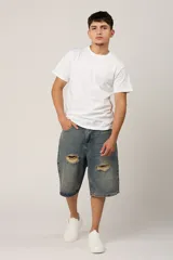 Bermuda de jean azul con efecto lavado y roturas en la parte delantera.