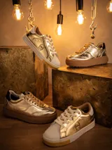 Championes de cuero metalizado en color dorado, con diseño inspirado en C-3PO. Presentan cordones al tono, suela de goma tipo plataforma en color marrón y detalles de marca Star Wars en la lengüeta y el frente.