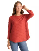 Blusa de tejido shaggy color terracota, con cuello a la base, mangas tres cuartos con tajo lateral en el puño y ruedo redondeado con largo posterior asimétrico.