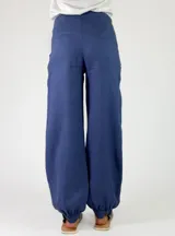 Pantalón de lino color rojo, de corte holgado con botamangas elastizadas y diseño cruzado en la cintura con lazo ajustable.