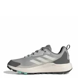 Championes de trekking Adidas Terrex Anylander, color gris con detalles en turquesa y suela en tono arena. Diseño técnico con refuerzos en la puntera y talón, ideales para actividades al aire libre.