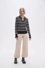 Sweater de punto a rayas horizontales negras y blancas, con cuello en V adornado con pequeños volados y mangas largas.
