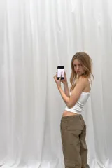 Pantalón cargo de tiro medio en color verde militar, con cierre frontal de cremallera y botones metálicos. Presenta bolsillos laterales, bolsillos de plastrón en las piernas con cierre de cremallera y trabillas en la cintura.