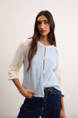 Saco de algodón tejido, color beige con mangas y detalles en blanco, escote en V y cierre frontal de botones.