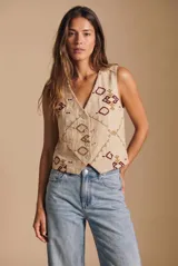 Chaleco de algodón color beige con estampado geométrico en tonos bordó y marrón. Presenta escote en V, cierre frontal con botones y corte recto.