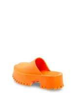 Zueco tipo mule color naranja, con plataforma y suela track.