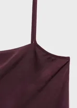 Top de breteles finos color borgoña, de tejido satinado y corte recto.