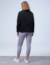 Buzo de jersey color lila con cuello alto y tajos laterales.