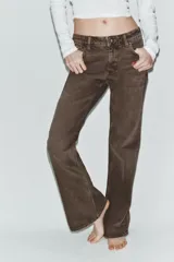 Jeans de tiro bajo con diseño bootcut y acabado flare en el bajo. Cuenta con cinco bolsillos, trabillas para cinturón y cierre frontal con cremallera y botón metálico.