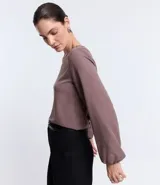 Blusa azul marino de crepé con escote redondo y mangas largas con puños elásticos.