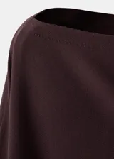 Poncho de punto asimétrico en color bordó, con diseño de capa y cuello barco de mangas amplias.