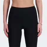Calza deportiva negra de talle alto, corte ajustado y largo hasta el tobillo. Presenta bolsillos laterales y un cordón interno en la cintura.