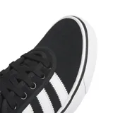 Championes Adidas modelo Adiease, de diseño urbano y estilo skate, confeccionados en gamuza negra con las tres tiras laterales en blanco y suela vulcanizada blanca.
