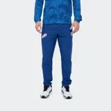 Pantalón deportivo Umbro del Club Nacional de Football, modelo Grok, color azul. Presenta el escudo del club en una pierna y el logo de Umbro en la otra.