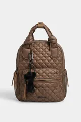 Mochila matelaseada de color marrón, con diseño acolchado de rombos, asas superiores con nudos y detalles en tono tostado. Cuenta con un bolsillo frontal con cierre, bolsillos laterales de red y un llavero decorativo con pompones y borla negra.