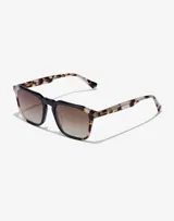 Lentes de sol unisex Hawkers con montura cuadrada negra y patillas con estampado carey.