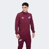 Campera deportiva Umbro del Club Nacional de Football, modelo Grok de color azul con estampado abstracto, cuello alto, cierre frontal completo y bolsillos laterales.