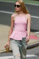 Top halter de mezcla de algodón en color rosado, con cuello halter ajustable mediante lazada, espalda descubierta y detalle de fajín cruzado con lazo en la cintura.