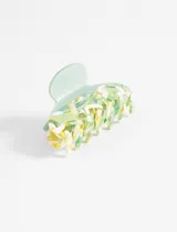 Broche de pelo tipo clip, color verde con diseño abstracto en tonos verdes, amarillos y blancos.