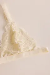 Sostén tipo bralette negro de encaje elastizado, con diseño triangular y breteles con detalle de encaje.