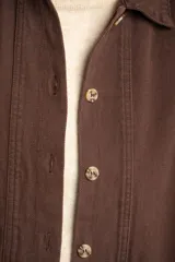 Sobrecamisa marrón de algodón con cuello camisero, cierre frontal con botones y bolsillos de parche en el pecho.