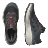 Championes de trail running Salomon Vision color gris oscuro, con detalles en rojo en los cordones, suela blanca y amortiguación texturizada.
