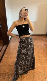 Top color crudo, sin mangas, con frunces en el busto y volados en el ruedo.