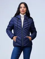 Campera de abrigo verde esmeralda, marca Michael Kors. Diseño acolchado con cierre metálico central, capucha no desmontable con cordón de ajuste y bolsillos verticales delanteros. Incluye bolsa autoportante.