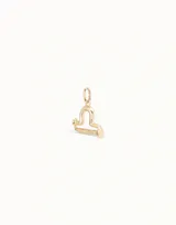 Dije dorado con forma del signo zodiacal Libra.
