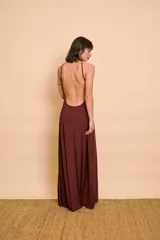 Vestido largo color bordó, de corte evasé con escote halter y espalda descubierta.