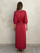 Vestido largo color ladrillo, de corte holgado, con cuello redondo y mangas 3/4 abullonadas.