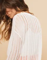 Sweater blanco de algodón con escote redondo, manga larga y calado en punto desagujado.