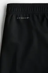Pantalón deportivo de fútbol en color negro con tecnología DryMove, de corte ajustado, con cintura elástica con cordón ajustable, bolsillos laterales con cierre y cierres en los tobillos.