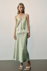 Vestido midi de satén color verde menta con escote en V, tirantes finos y detalle de encaje blanco en el pecho.