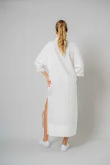 Vestido camisero blanco de lino, largo midi, con cuello camisero, mangas 3/4 y cierre frontal con botones.