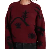 Buzo de punto color bordó con estampado gráfico en negro, cuello redondo, mangas largas y corte holgado tipo crop.